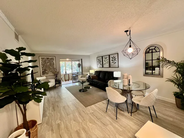 a living room with furniture a fireplace and wooden floor