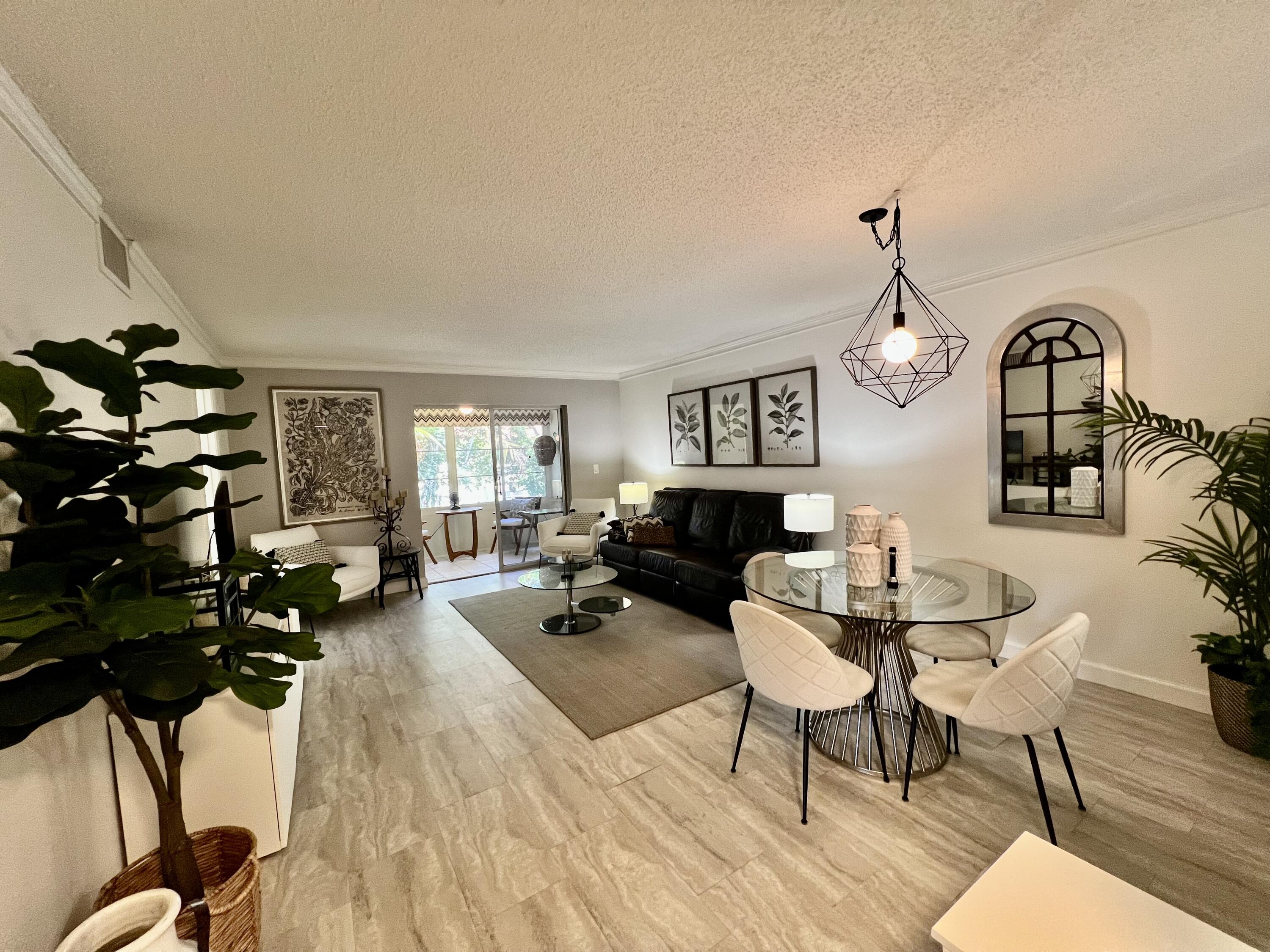 5640 Southwest 3rd Place, Unit 217 Margate, FL 33068 - Photo 16 of 32 a living room with furniture a fireplace and wooden floor