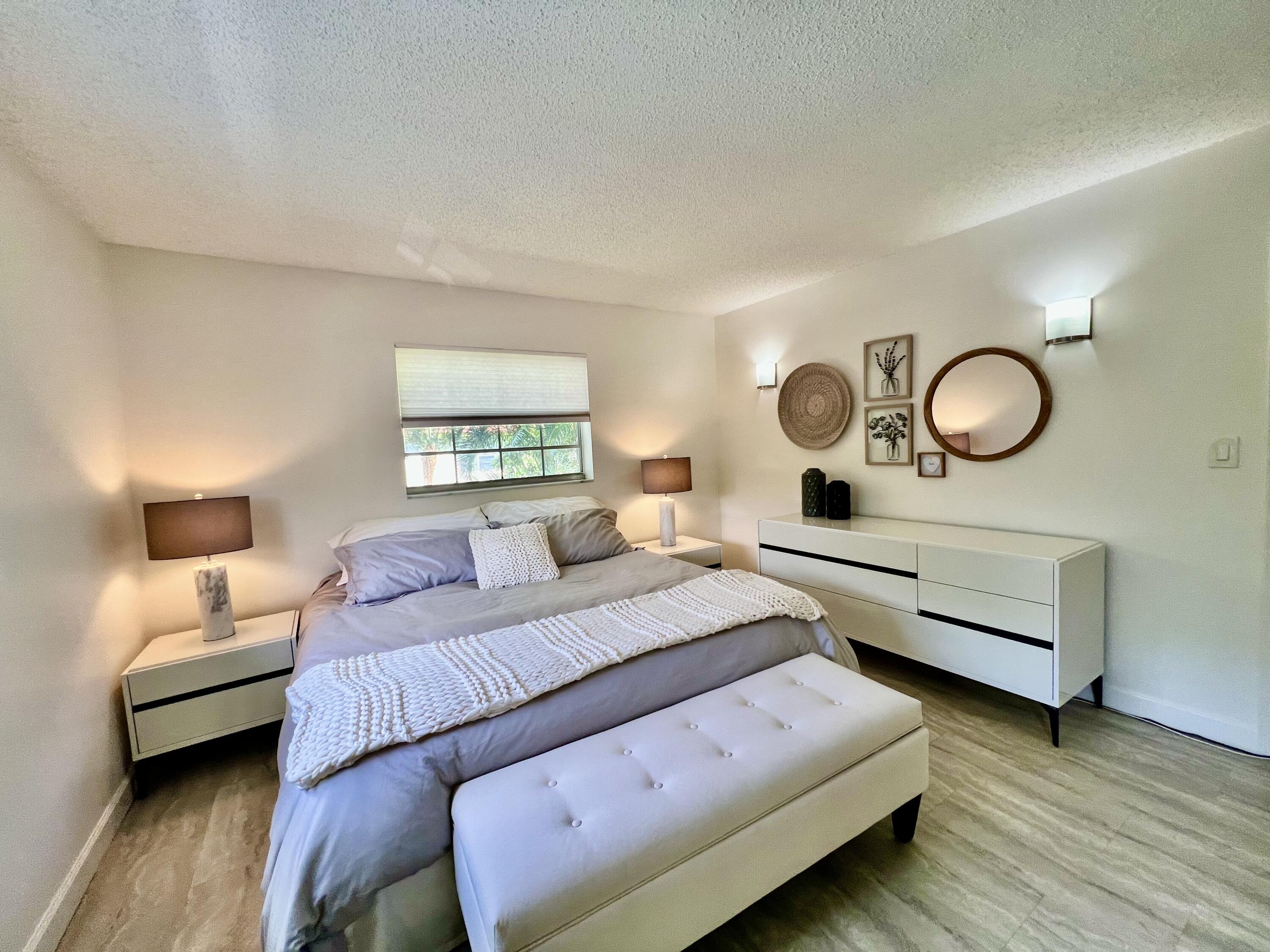 5640 Southwest 3rd Place, Unit 217 Margate, FL 33068 - Photo 18 of 32 a bedroom with bed and a chandelier