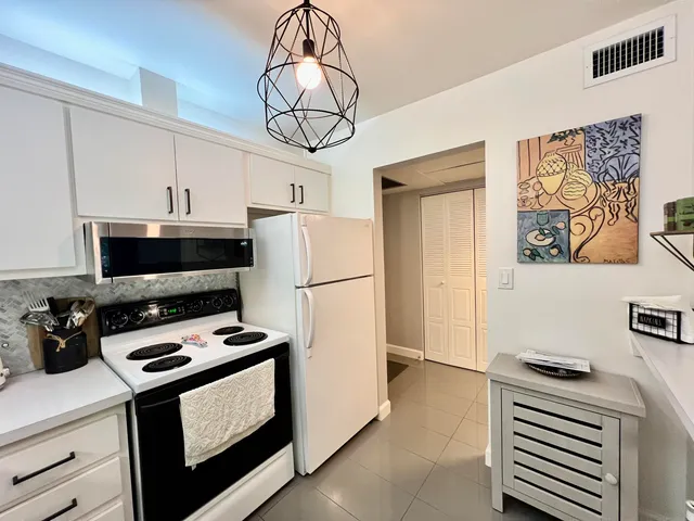 a kitchen with a appliances a stove a microwave and a refrigerator