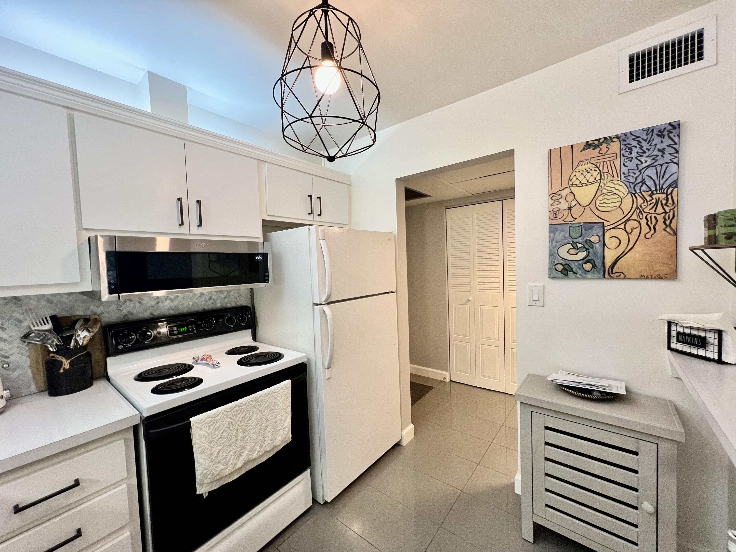 5640 Southwest 3rd Place, Unit 217 Margate, FL 33068 - Photo 19 of 32 a kitchen with a appliances a stove a microwave and a refrigerator