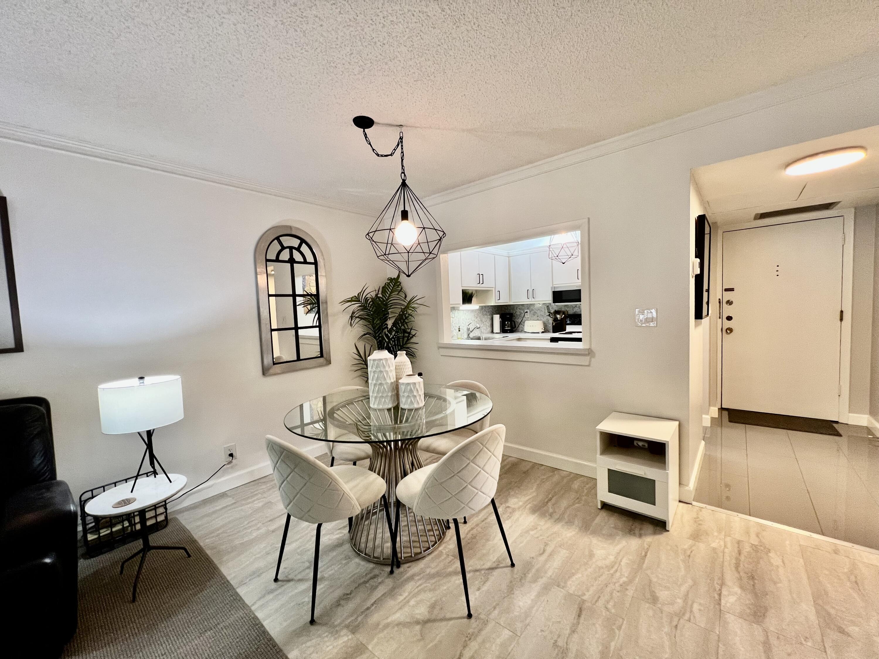 5640 Southwest 3rd Place, Unit 217 Margate, FL 33068 - Photo 2 of 32 a view of a dining room with furniture and wooden floor