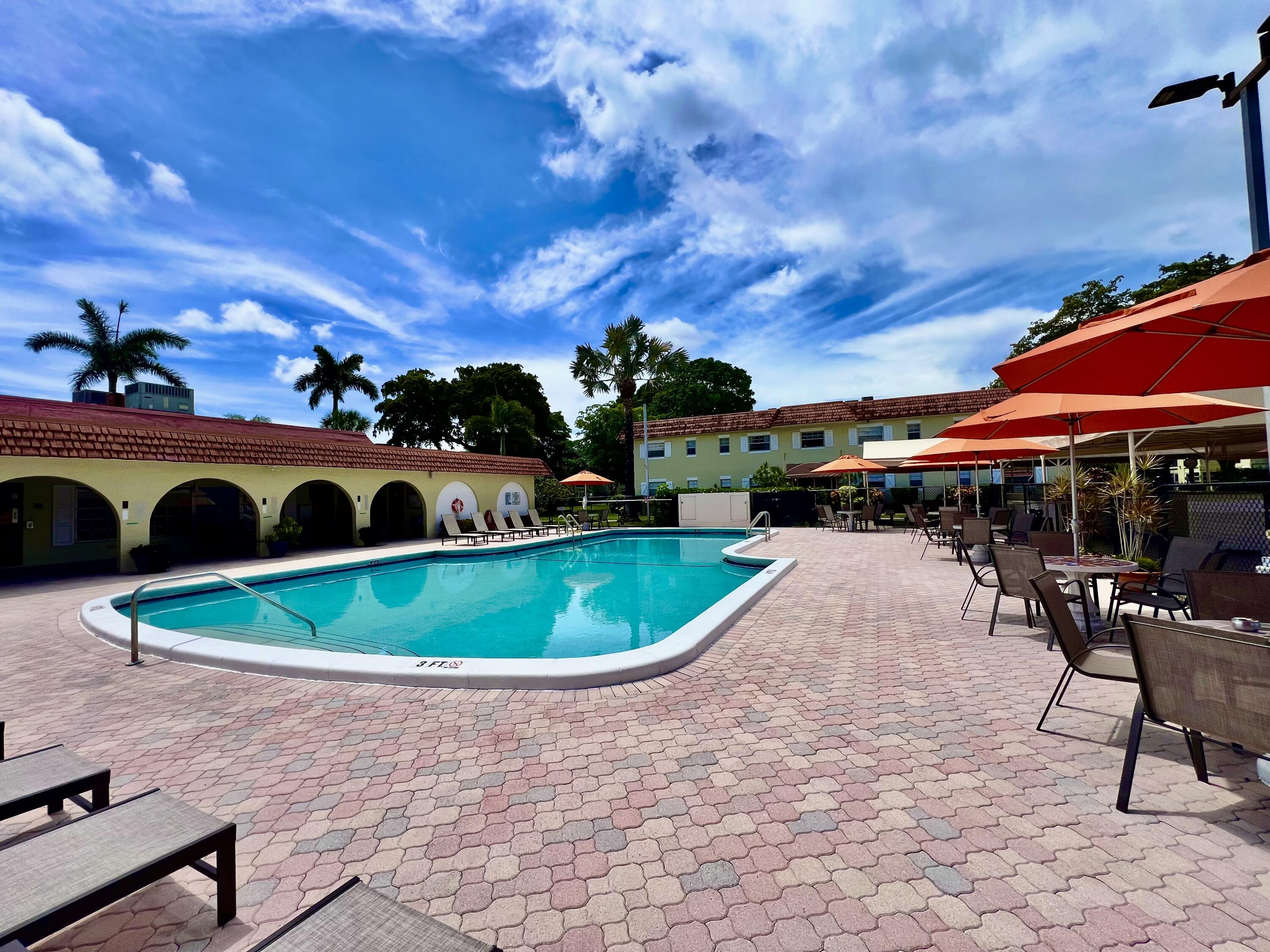 5640 Southwest 3rd Place, Unit 217 Margate, FL 33068 - Photo 21 of 32 a table and chairs in the patio