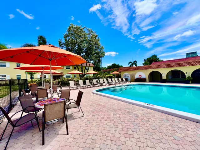 a view of a swimming pool with sitting area