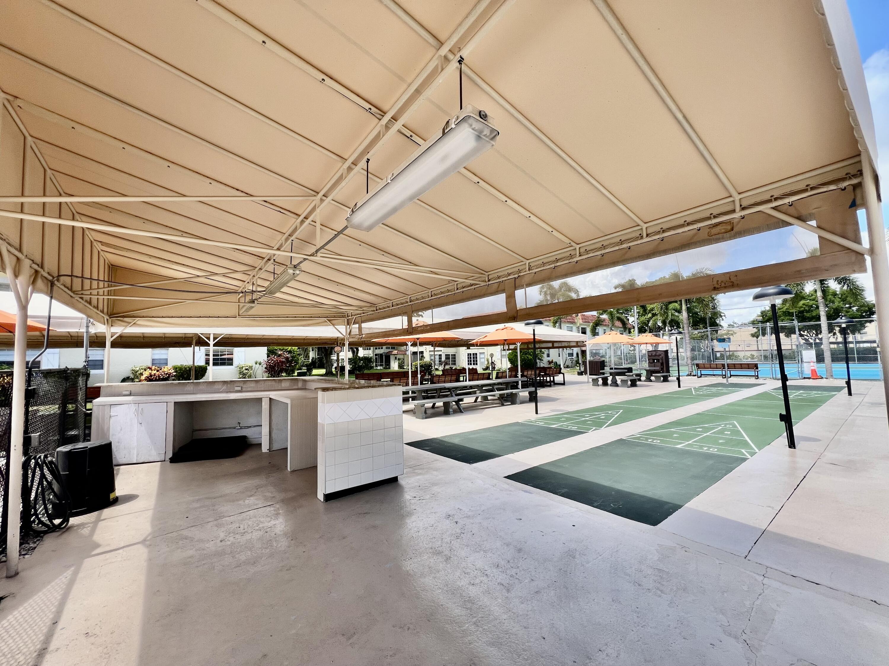 5640 Southwest 3rd Place, Unit 217 Margate, FL 33068 - Photo 25 of 32 a view of a swimming pool with a patio