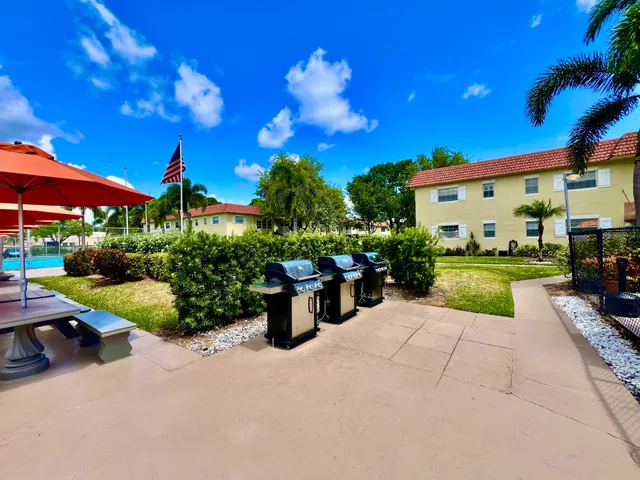a view of an house with backyard and sitting area
