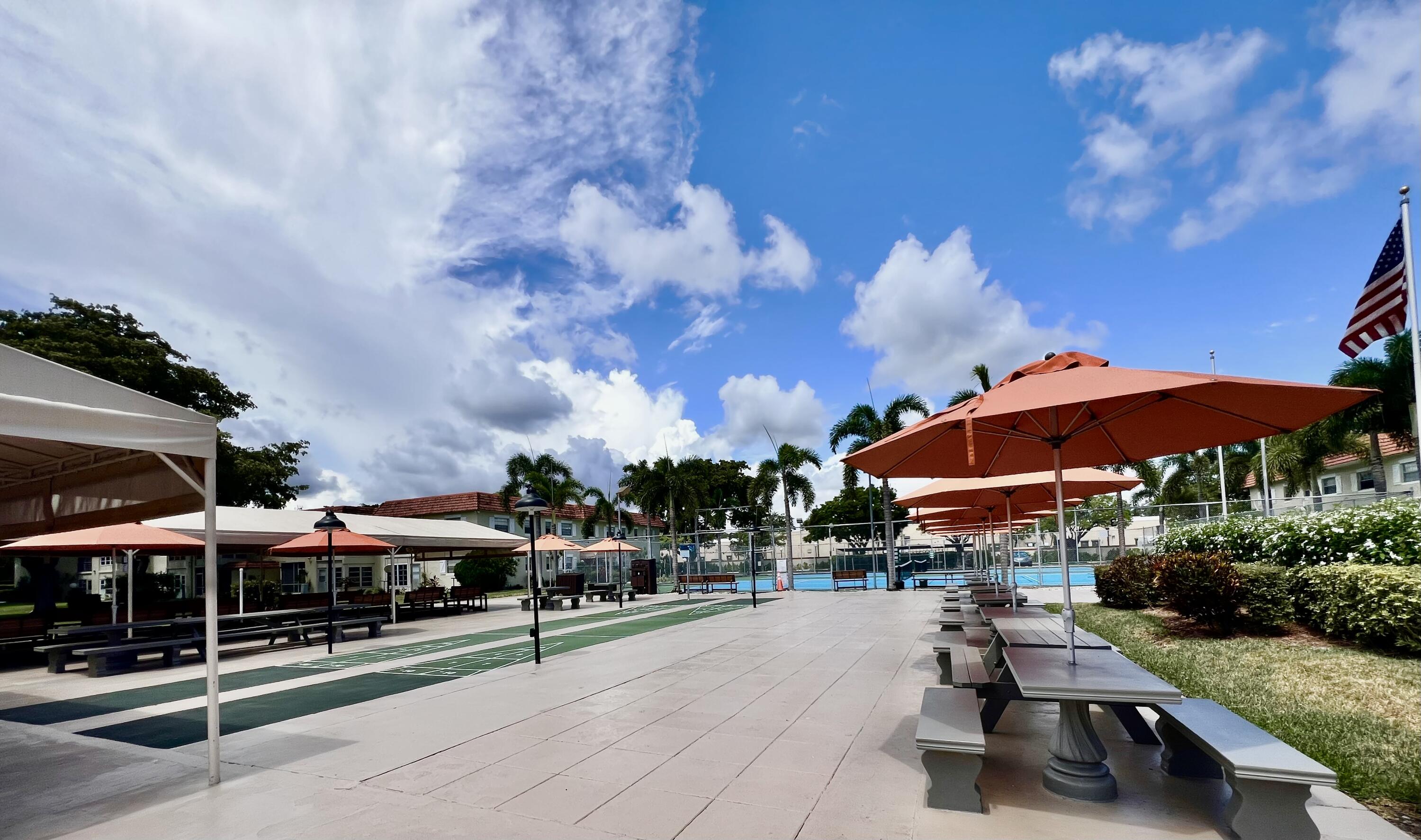 5640 Southwest 3rd Place, Unit 217 Margate, FL 33068 - Photo 31 of 32 a group of lawn chairs under an umbrella