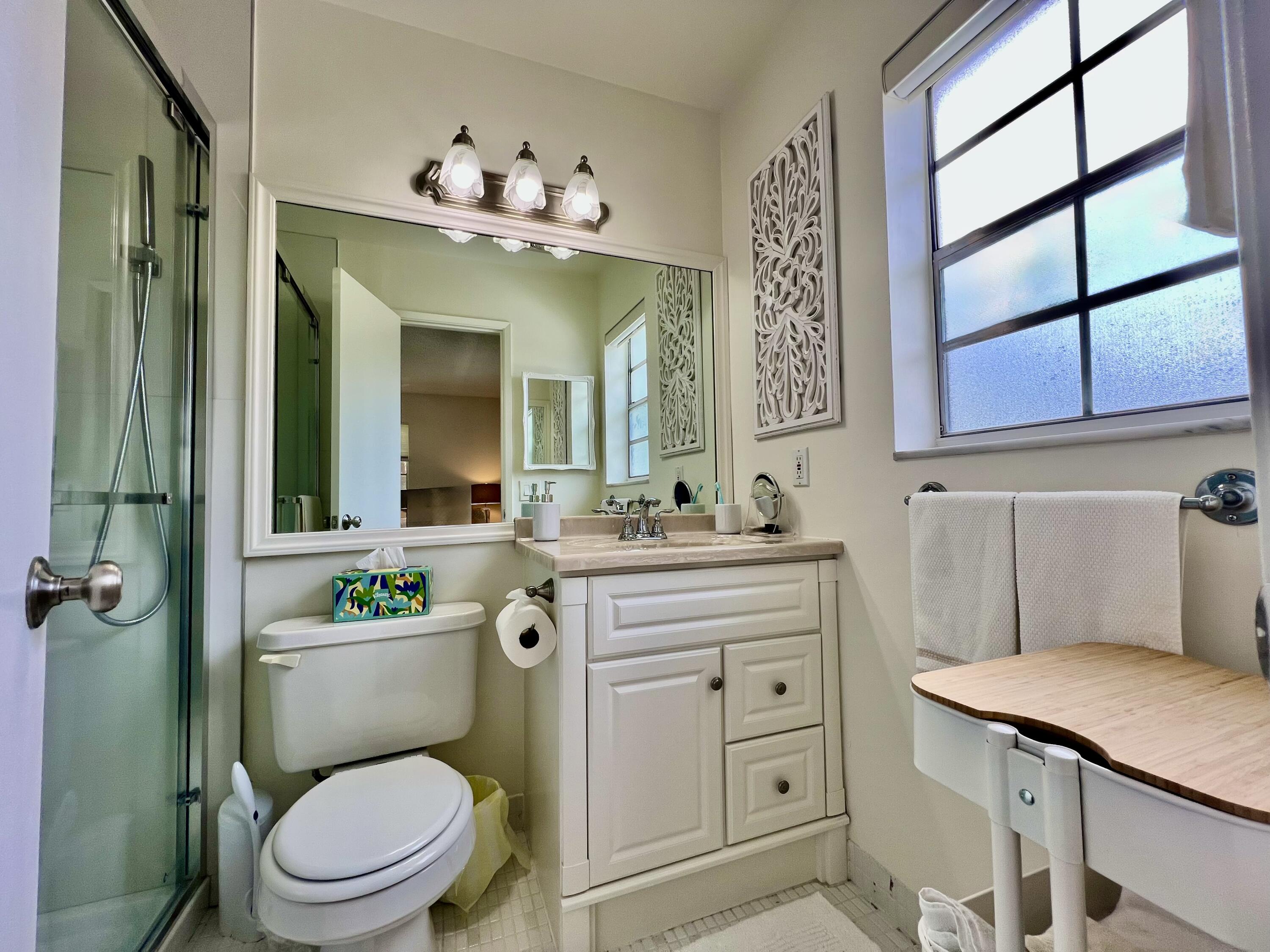 5640 Southwest 3rd Place, Unit 217 Margate, FL 33068 - Photo 6 of 32 a bathroom with a toilet sink and mirror