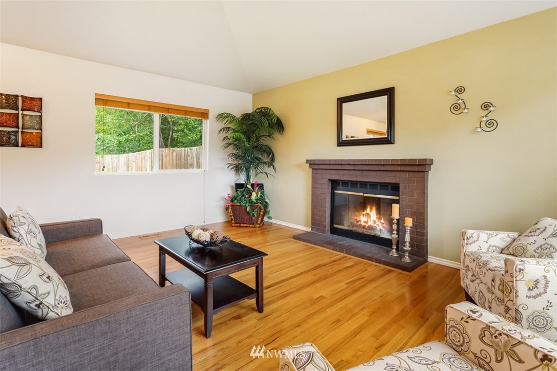 1229 221st Place Southwest Bothell, WA 98021 - Photo 3 of 25 a living room with furniture and a fireplace