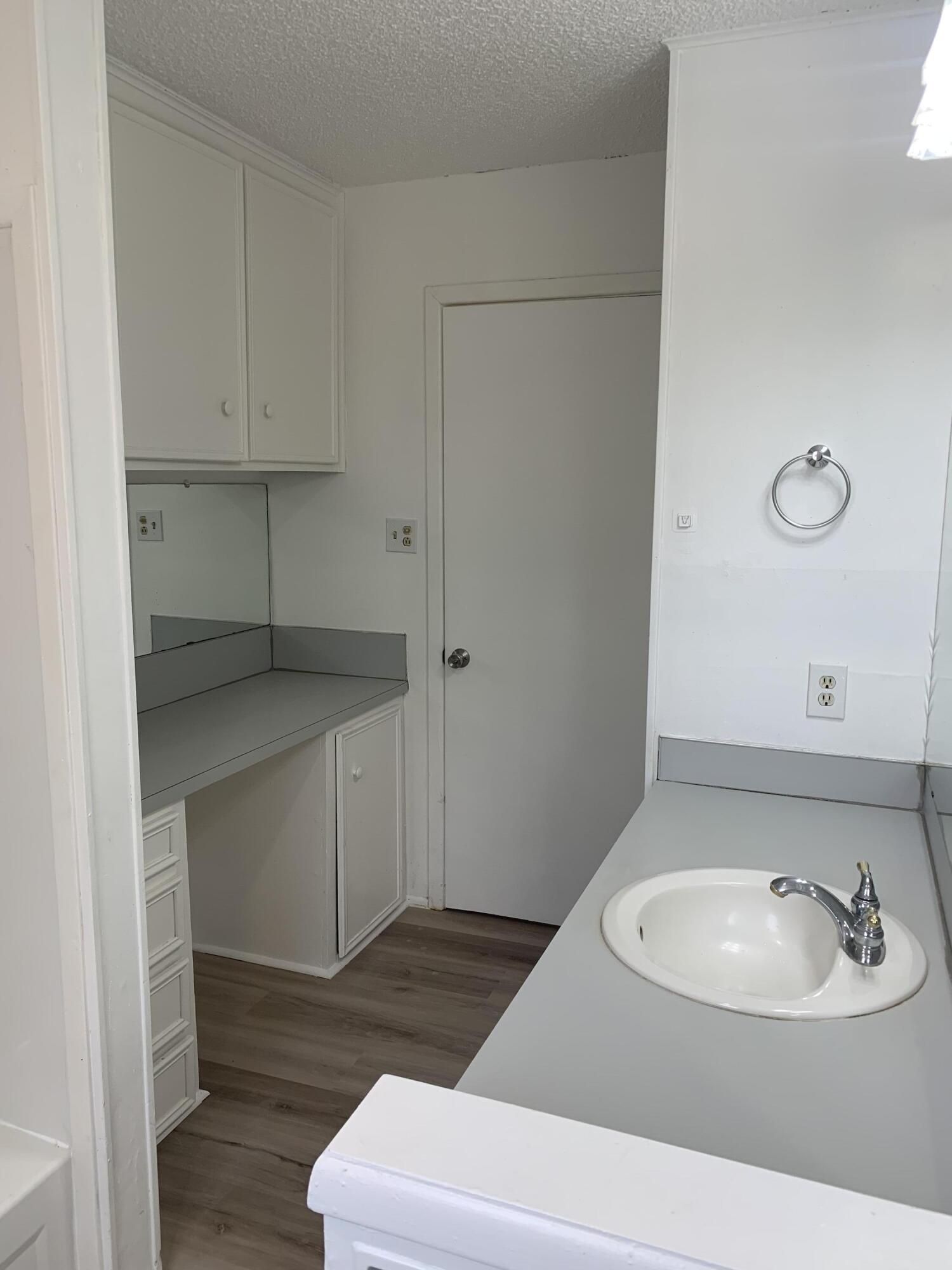 750 South 13th Street Slaton, TX 79364 - Photo 9 of 13 a bathroom with a sink and a mirror