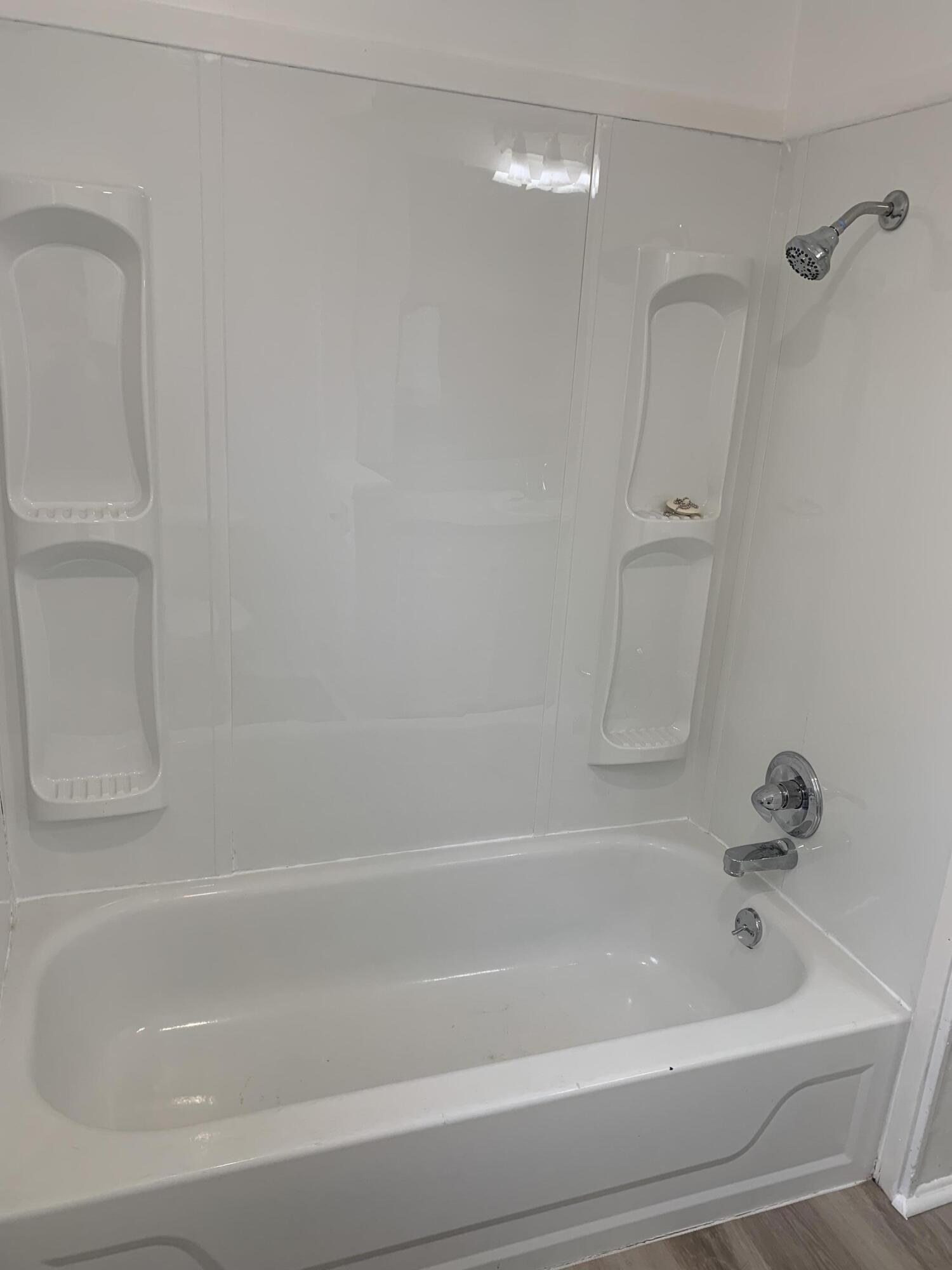 750 South 13th Street Slaton, TX 79364 - Photo 10 of 13 a bathroom with a bathtub