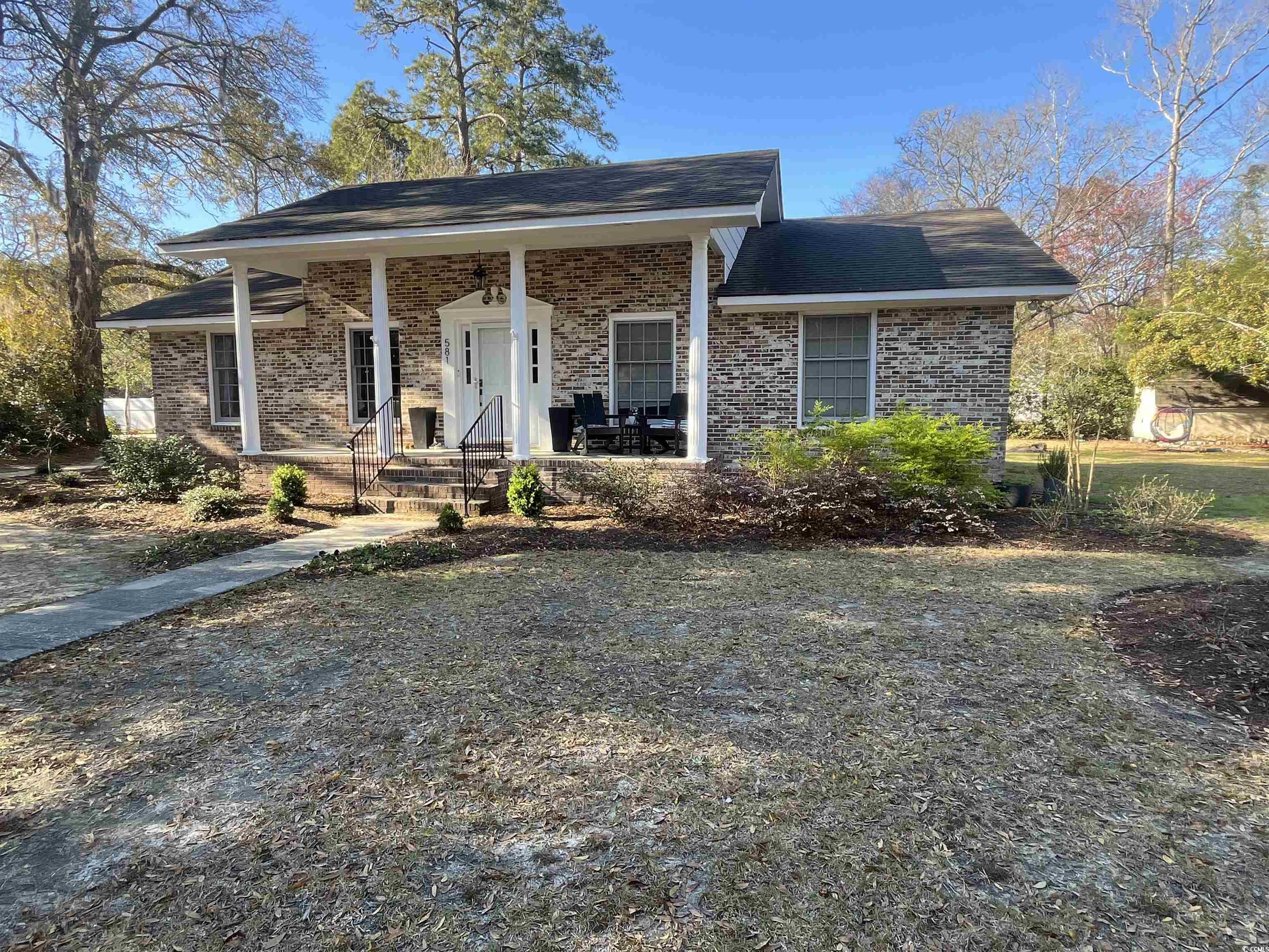 581 Vaux Hall Avenue Murrells Inlet, SC 29576 - Photo 1 of 2 View of front facade featuring brick siding, a por