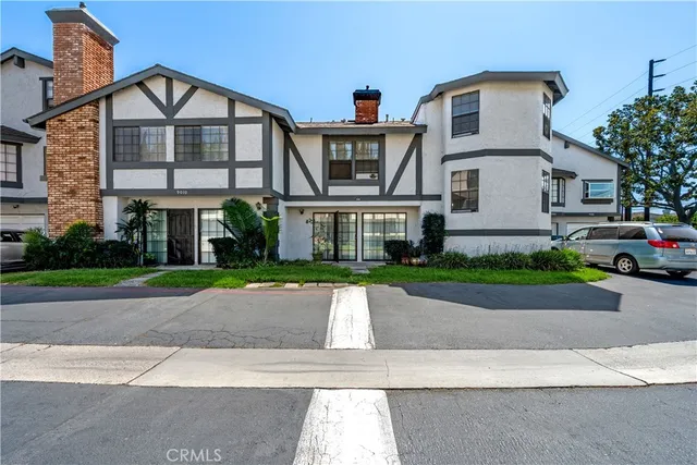 a front view of a house with a yard and a garage