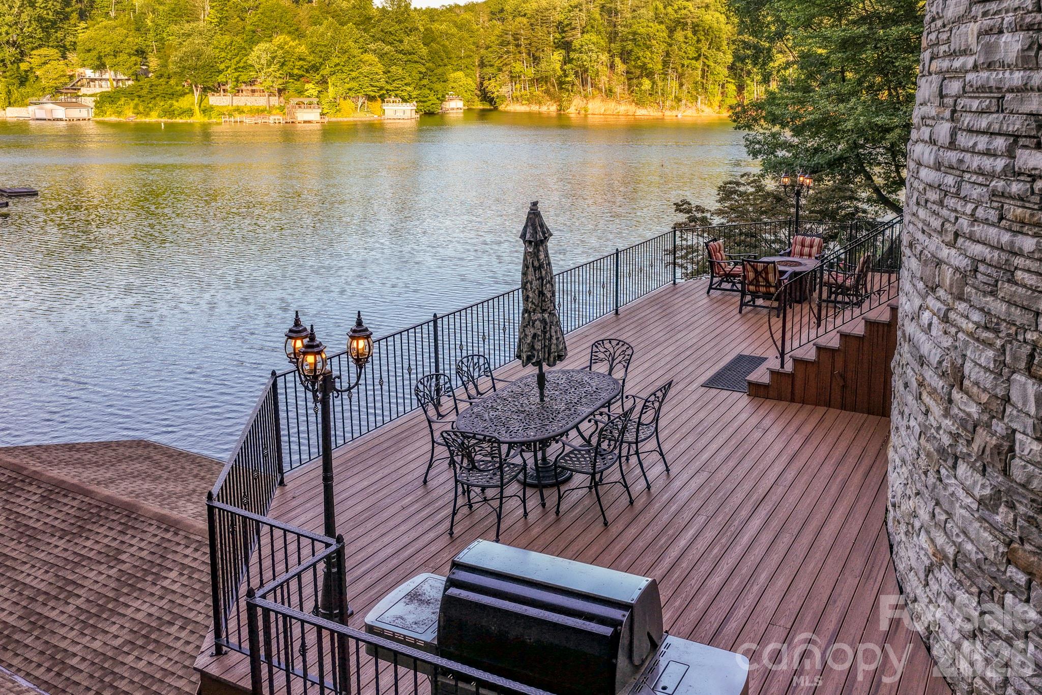 151 Garner Road Lake Lure, NC 28746 - Photo 41 of 48 a view of a balcony with chairs and wooden floor