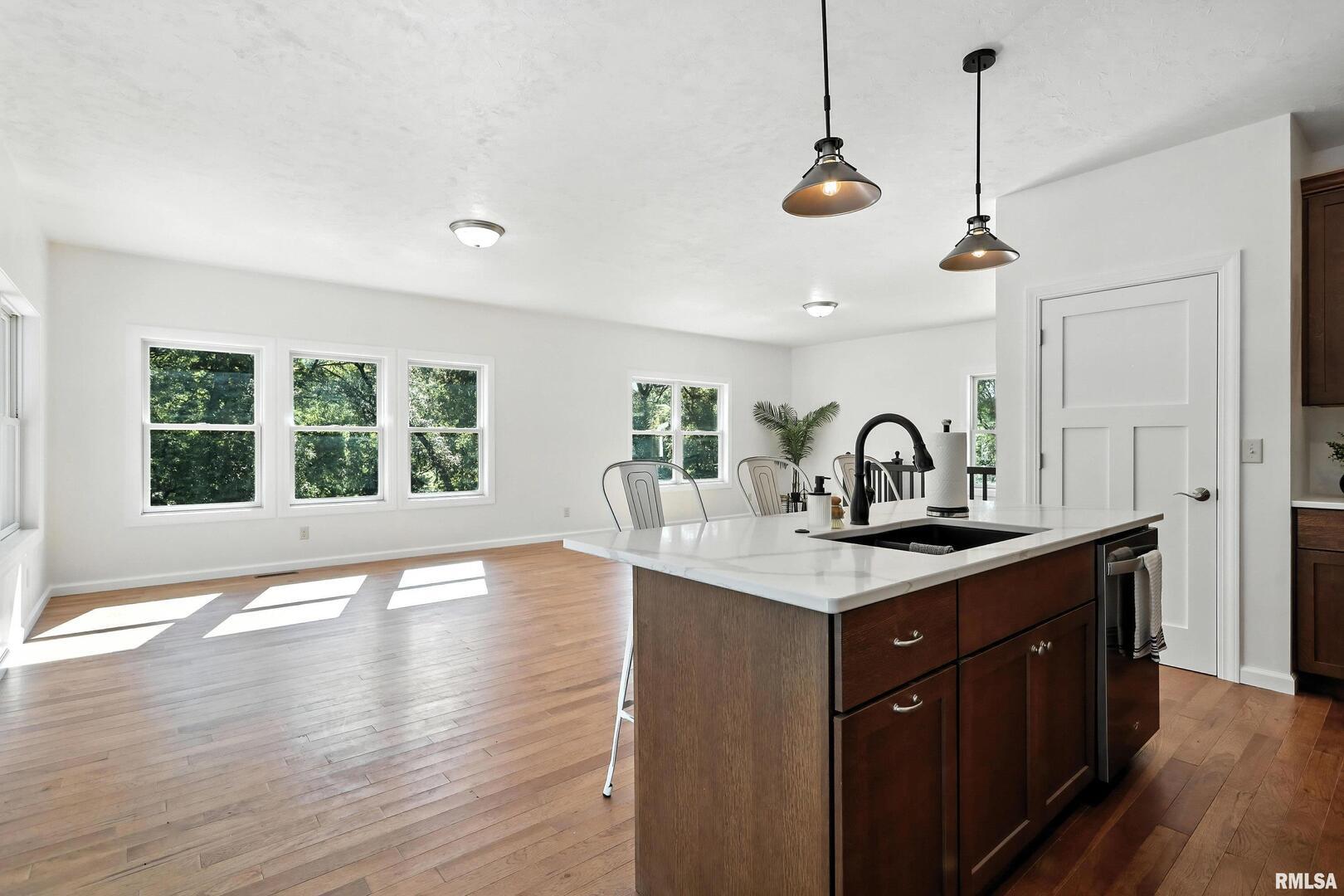 3303 Valley Drive Geneseo, IL 61254 - Photo 11 of 50 a kitchen with a sink a window and wooden floor