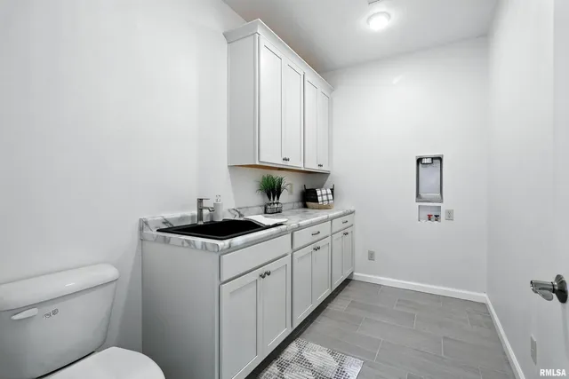 a kitchen with sink stove and cabinets