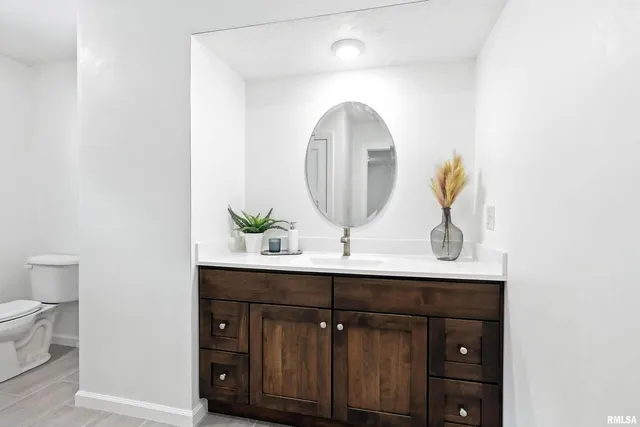 a bathroom with a double vanity sink and a mirror