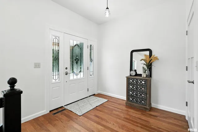 a view of room with window and wooden floor