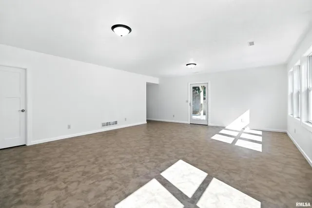 a living room with furniture and white walls
