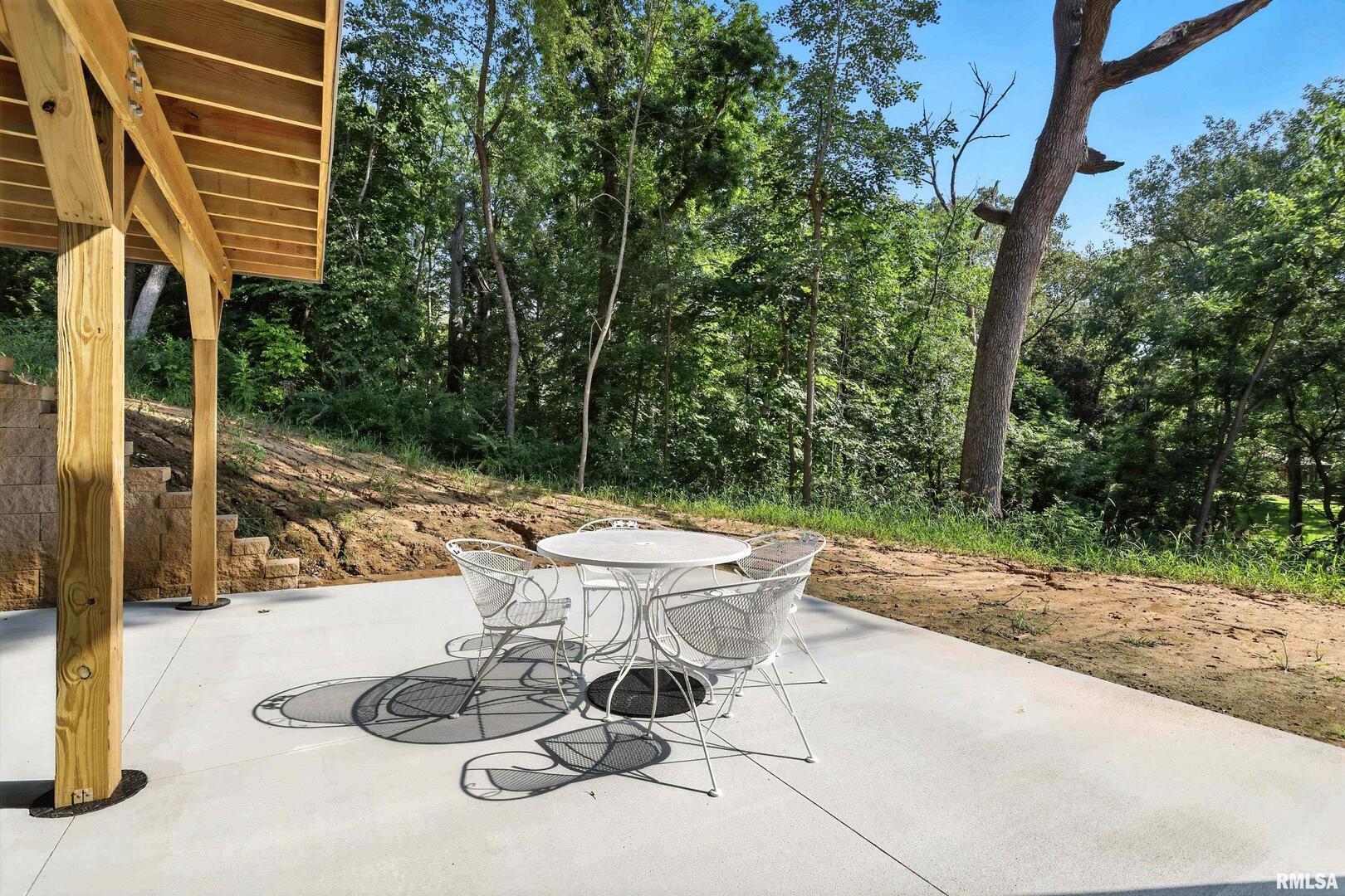 3303 Valley Drive Geneseo, IL 61254 - Photo 35 of 50 a view of a patio with table and chairs and potted plants with wooden fence