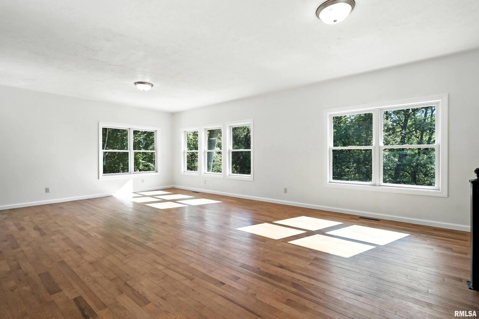 3303 Valley Drive Geneseo, IL 61254 - Photo 5 of 50 a view of empty room with wooden floor and fan