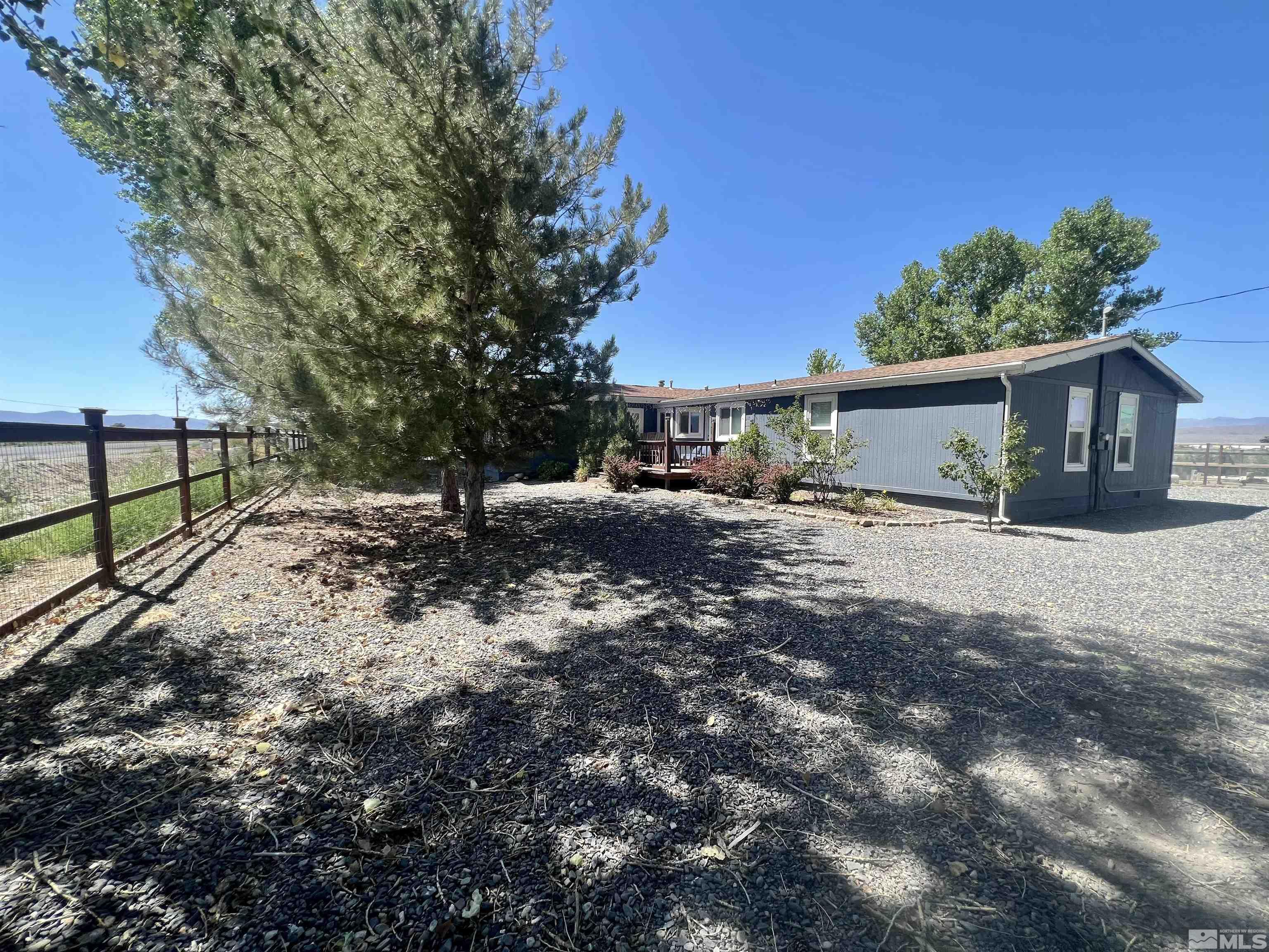 1405 South Meridian Road Lovelock, NV 89419 - Photo 2 of 39 a backyard of a house with table and chairs