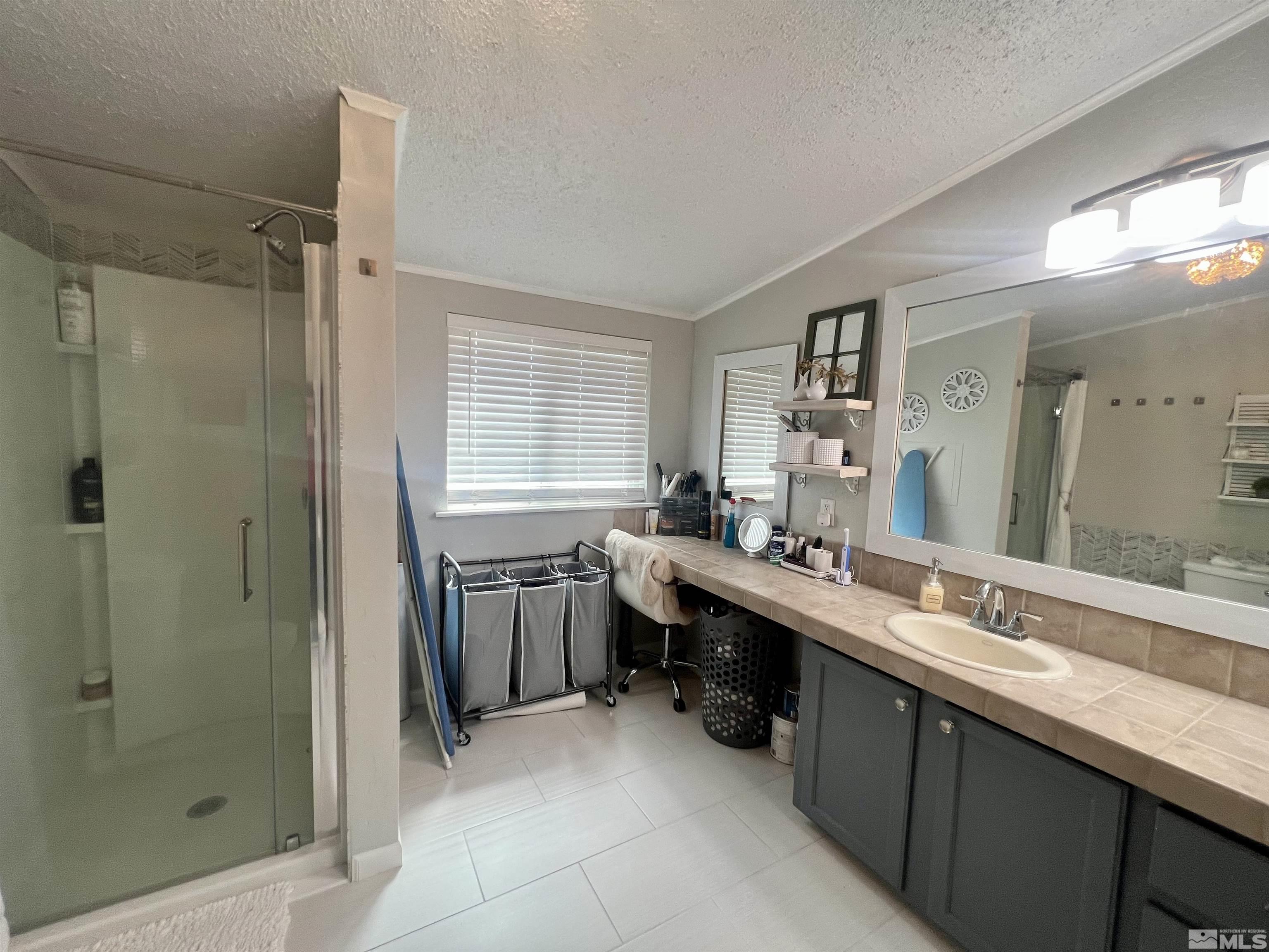 1405 South Meridian Road Lovelock, NV 89419 - Photo 23 of 39 a bathroom with a sink double vanity granite tub shower and mirror