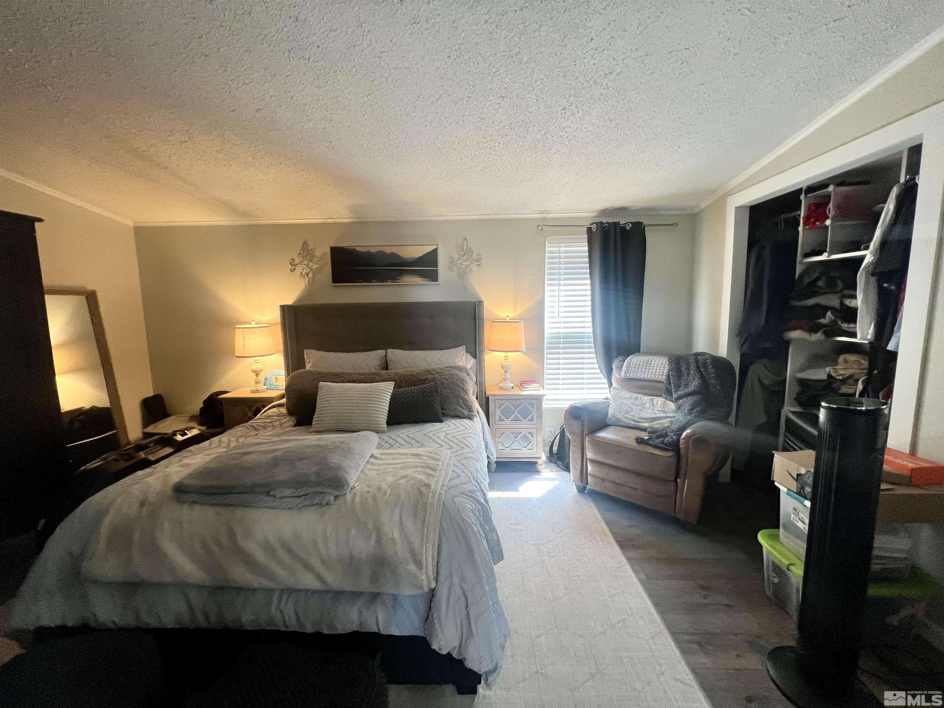 1405 South Meridian Road Lovelock, NV 89419 - Photo 24 of 39 a bedroom with a bed a couch and a flat tv screen
