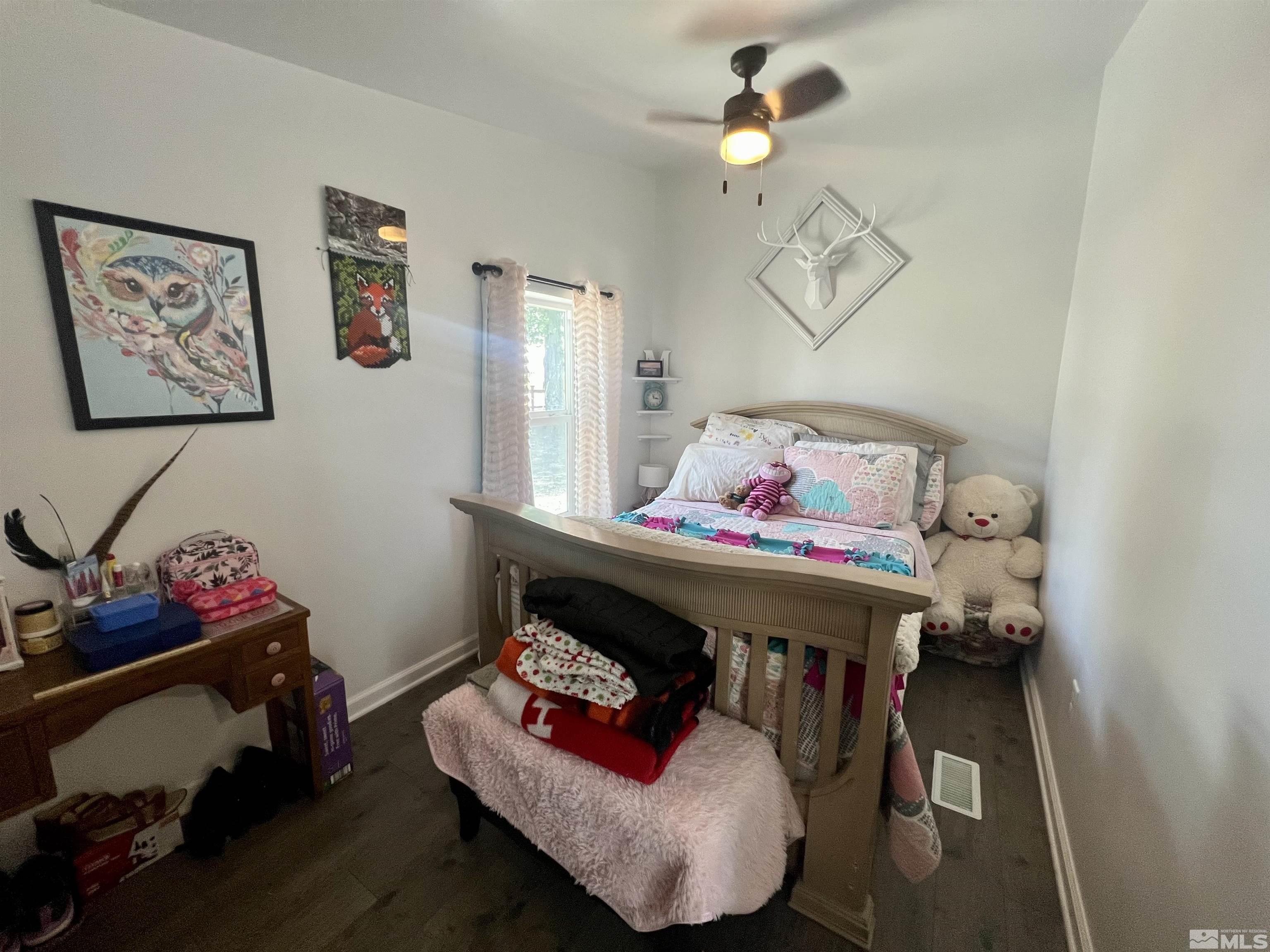 1405 South Meridian Road Lovelock, NV 89419 - Photo 26 of 39 a bedroom with a bed and wooden floor