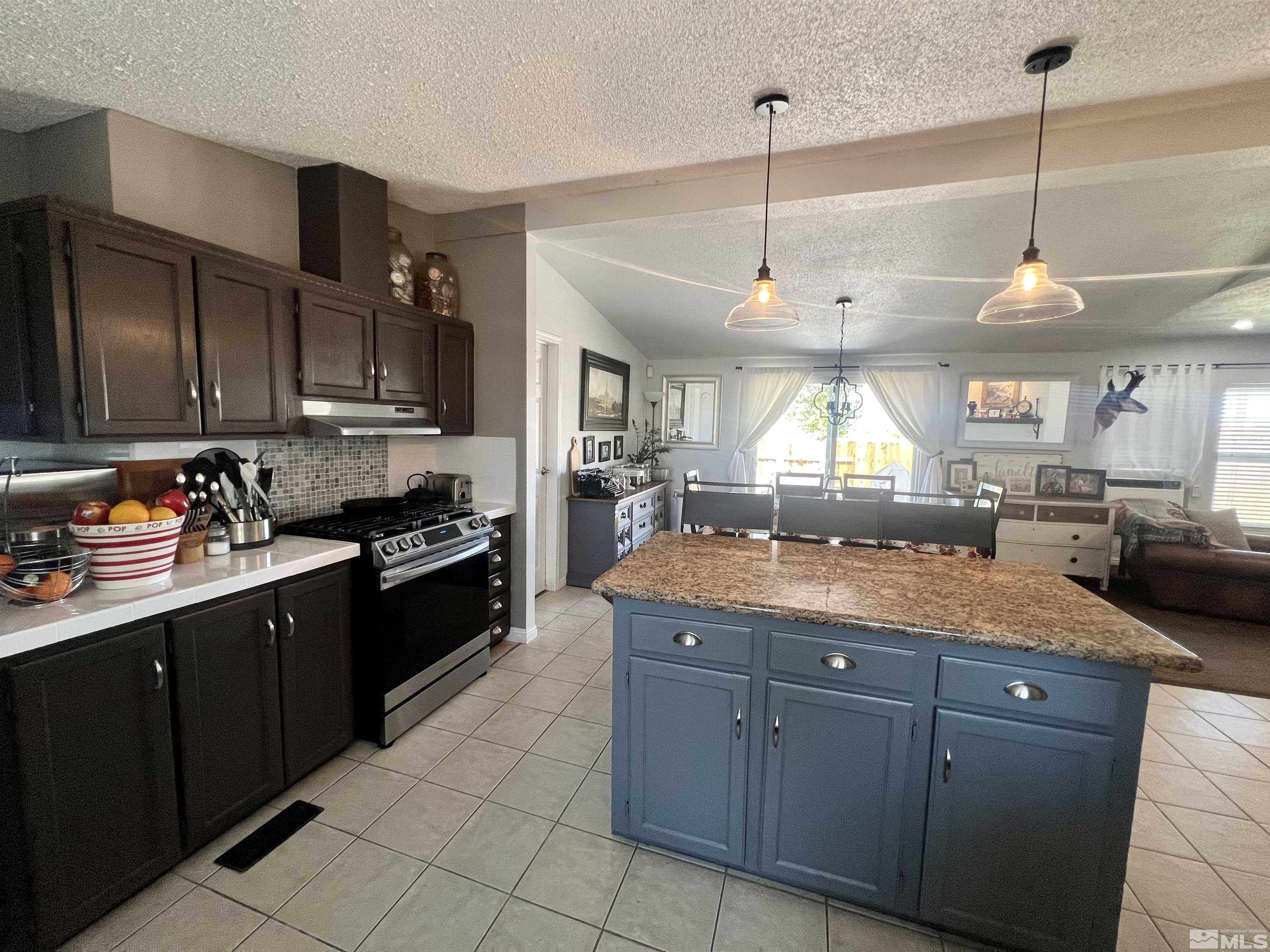 1405 South Meridian Road Lovelock, NV 89419 - Photo 31 of 39 a kitchen with granite countertop a sink a counter space appliances and cabinets