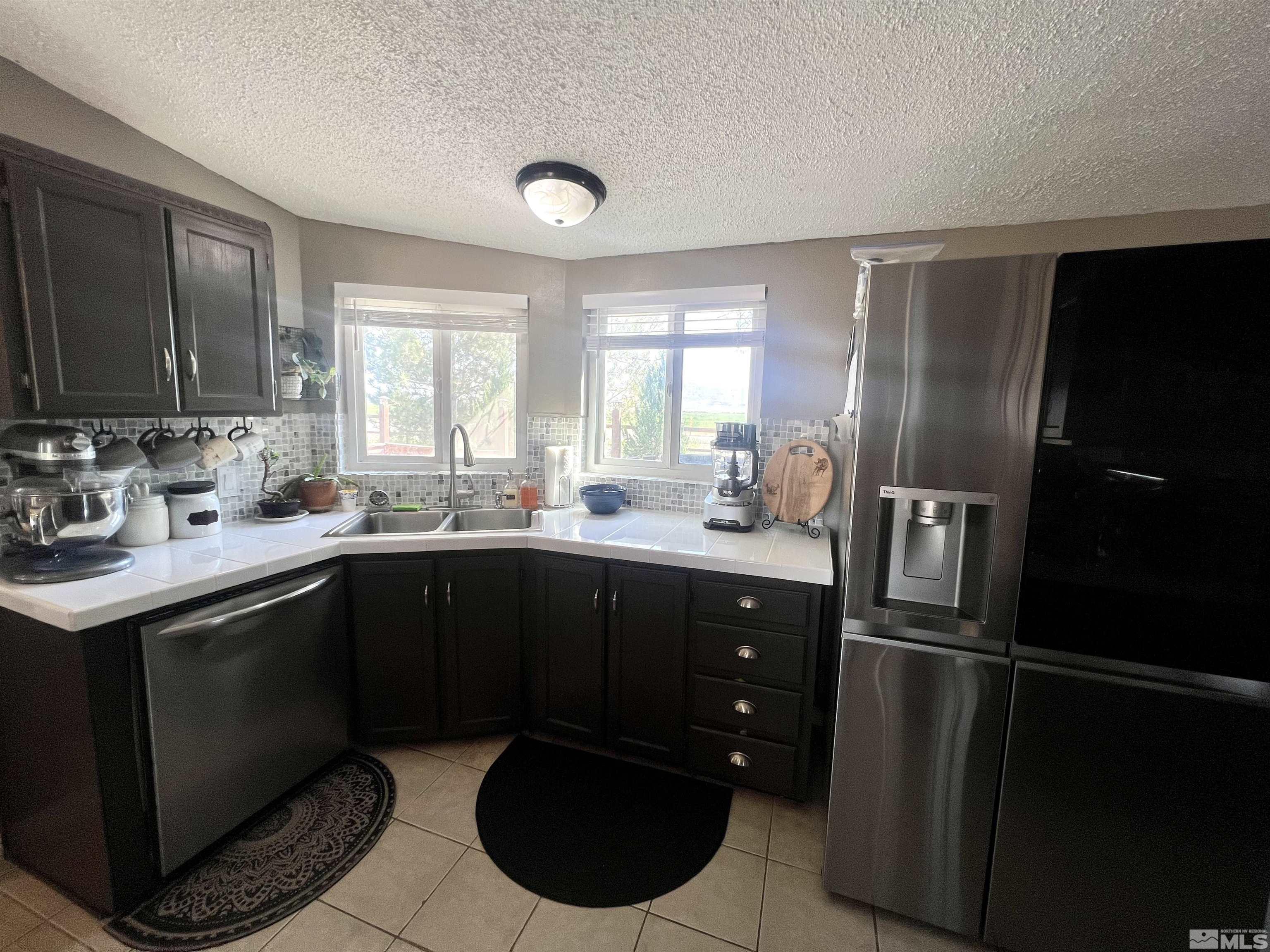 1405 South Meridian Road Lovelock, NV 89419 - Photo 32 of 39 a kitchen with a sink stainless steel appliances and cabinets