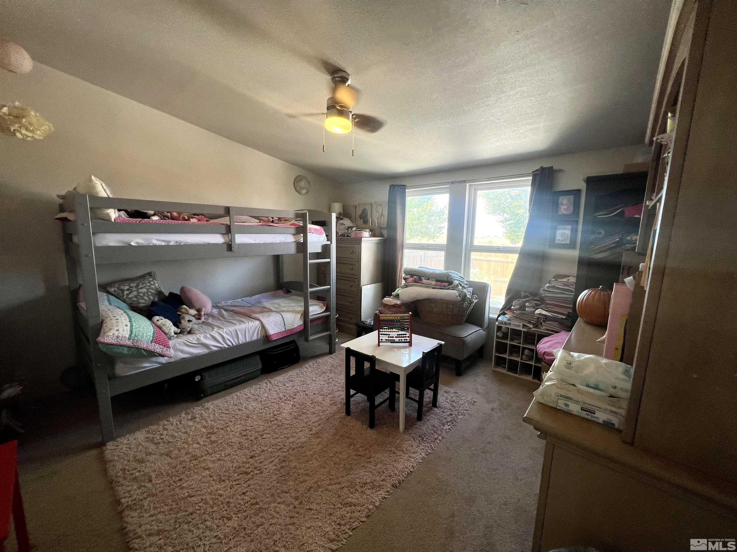 1405 South Meridian Road Lovelock, NV 89419 - Photo 35 of 39 a bedroom with furniture and a chandelier