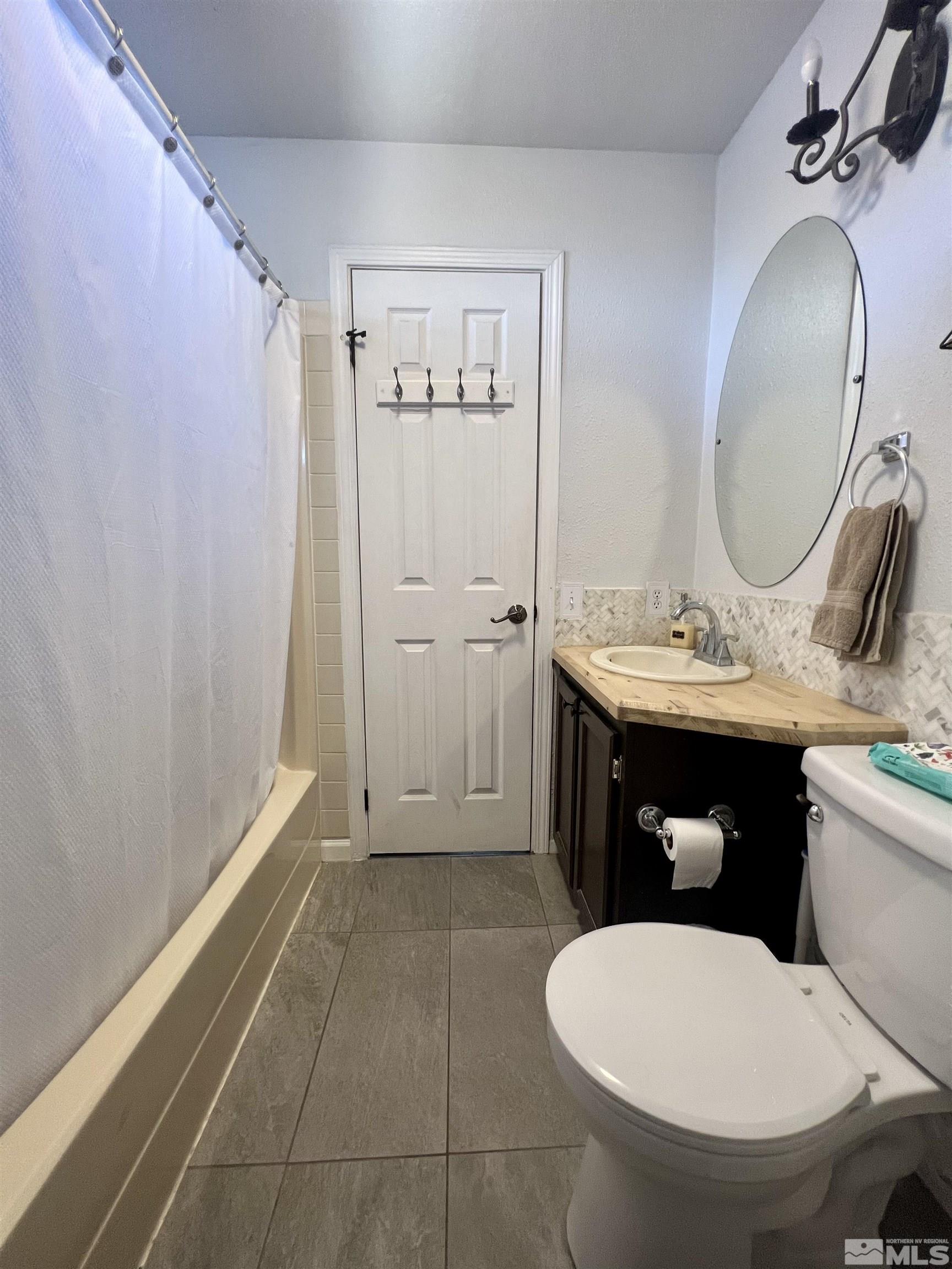 1405 South Meridian Road Lovelock, NV 89419 - Photo 37 of 39 a bathroom with a toilet sink and mirror