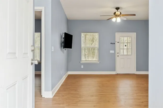 a view of livingroom with hardwood floor and a ceiling fan