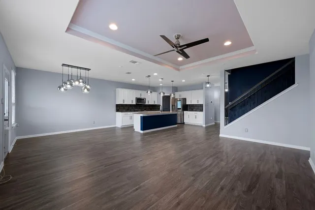 a view of a kitchen with a sink and a stove top oven