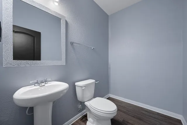 a bathroom with a sink toilet and a mirror