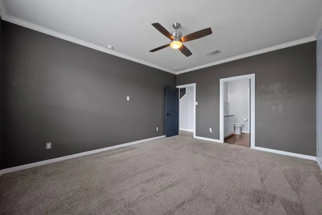 a view of an empty room with a ceiling fan and window