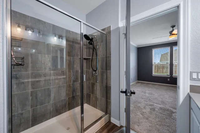a bathroom with a glass shower door