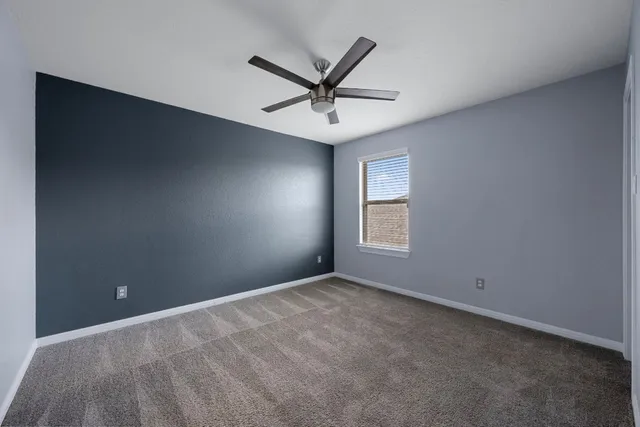 a view of a ceiling fan and a window