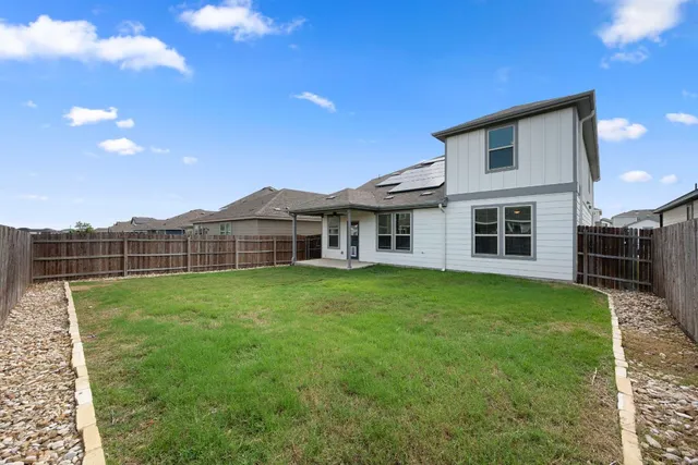 a view of a house with backyard and porch