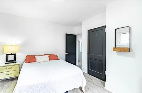 a bedroom with a bed and a dresser