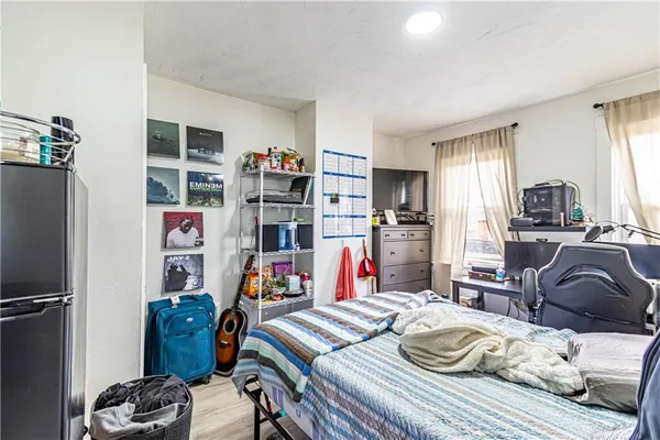 a bedroom with furniture and a wooden floor