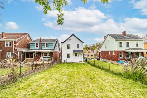 a view of a house with swimming pool and sitting area