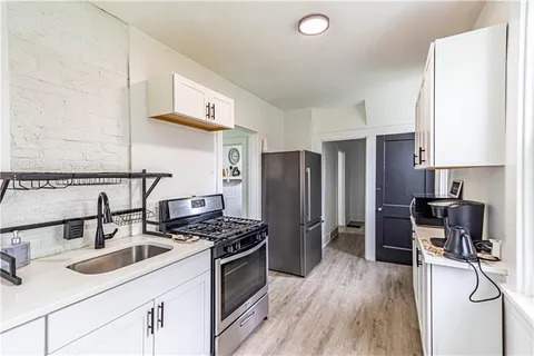a kitchen with a refrigerator sink and stove