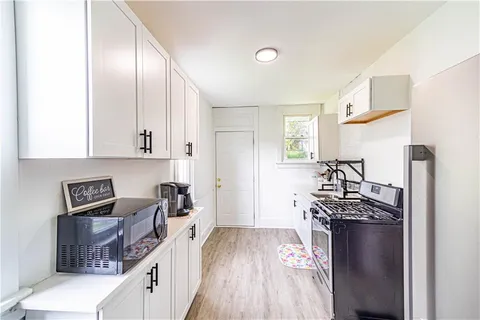 a kitchen with stainless steel appliances granite countertop a stove and a refrigerator