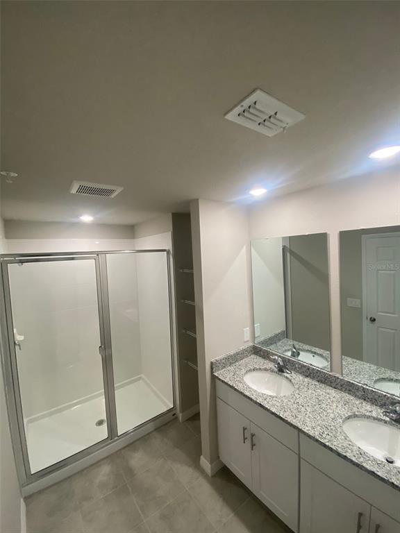 2534 Red Spruce Way Ocoee, FL 34761 - Photo 9 of 16 a bathroom with a double vanity sink and mirror