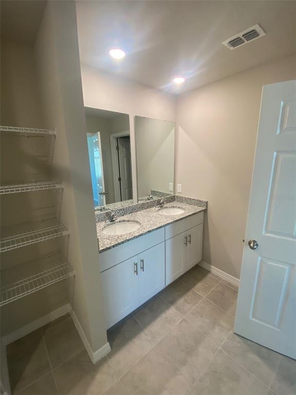 2534 Red Spruce Way Ocoee, FL 34761 - Photo 10 of 16 a bathroom with a granite countertop sink and a mirror