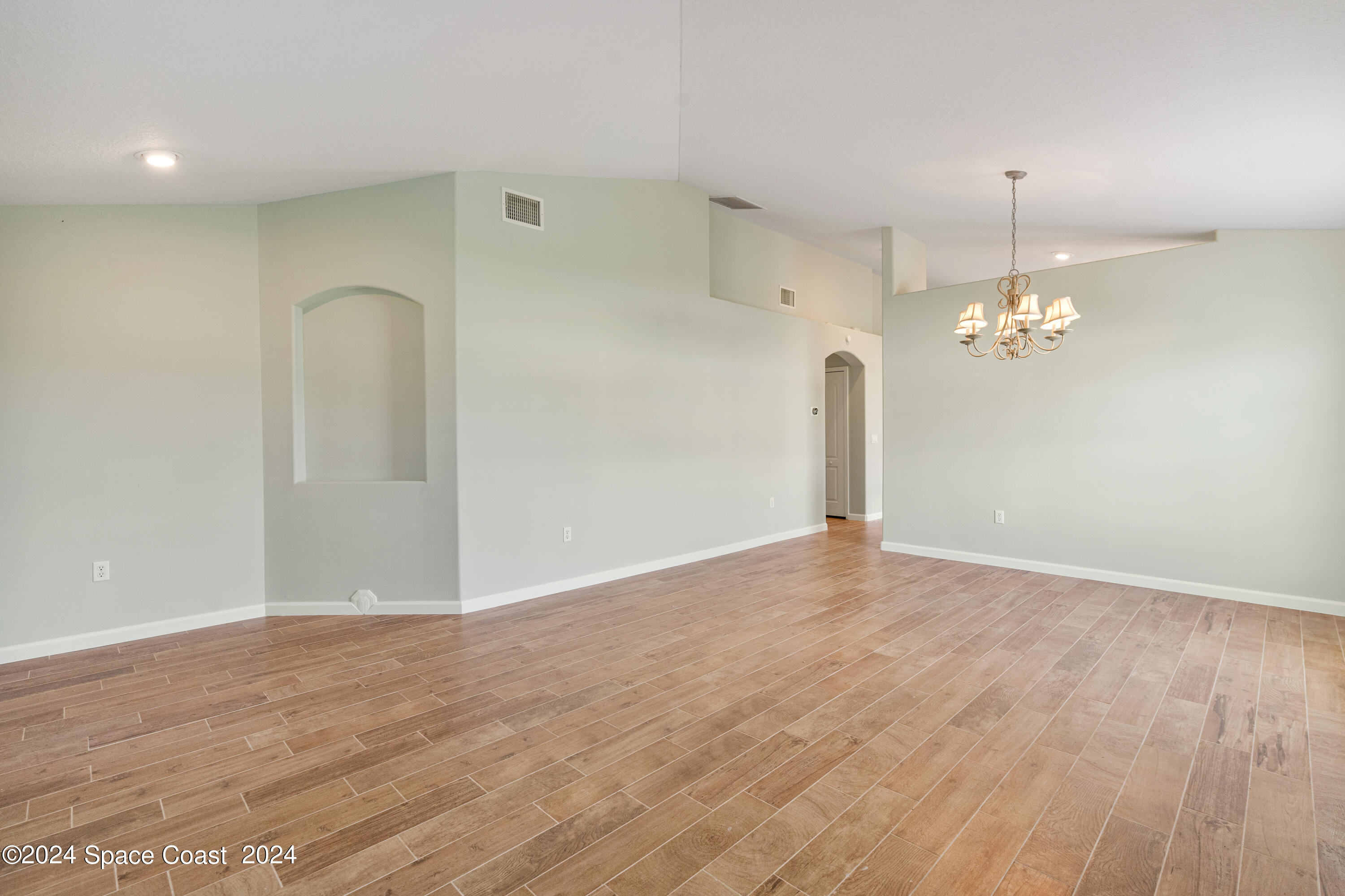 4220 Chardonnay Drive Rockledge, FL 32955 - Photo 15 of 51 a view of empty room with wooden floor and ceiling fan