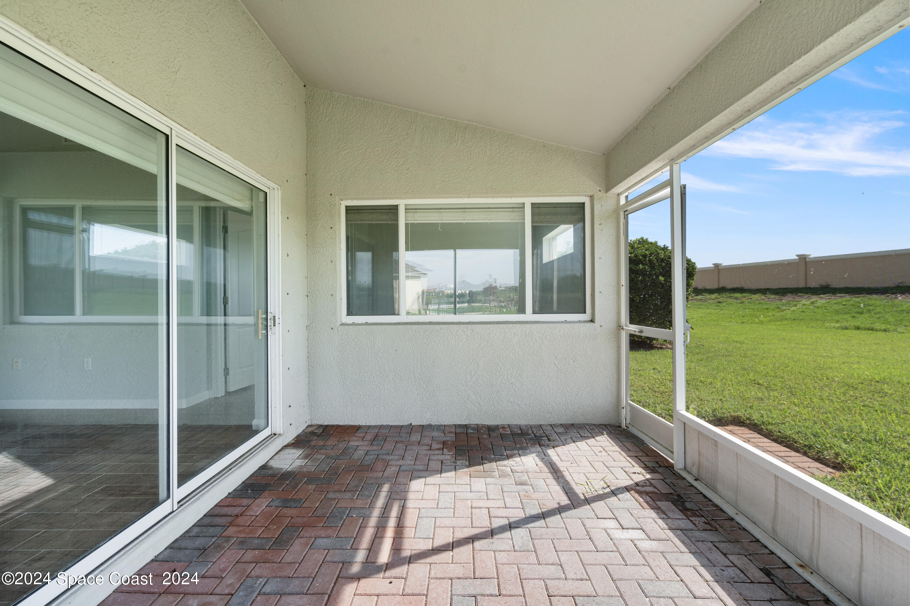 4220 Chardonnay Drive Rockledge, FL 32955 - Photo 20 of 51 a view of a balcony with floor to ceiling window next to a yard