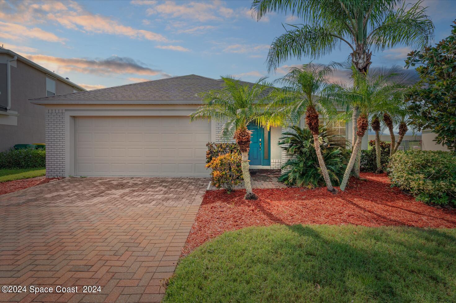 4220 Chardonnay Drive Rockledge, FL 32955 - Photo 2 of 51 a front view of a house with a yard and garage